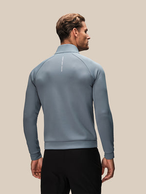 Back view of light blue Reiss x Castore hybrid jacket with vertical logo along the spine.