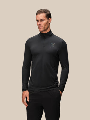 Male model wearing black long sleeve quarter zip top from Reiss x Castore front view