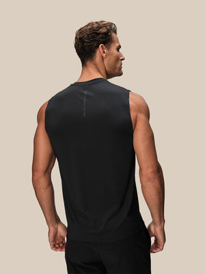 Back view of male model wearing black Reiss x Castore performance vest with vertical branding
