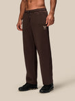Brown wide leg fleece joggers with drawstring waistband and small logo on the thigh