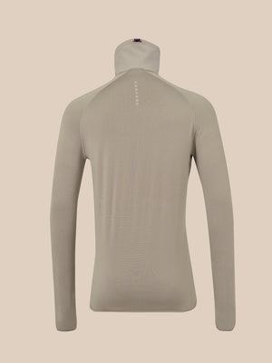 A light taupe long-sleeve mock neck athletic top shown from the back on a mannequin, against a solid beige background.