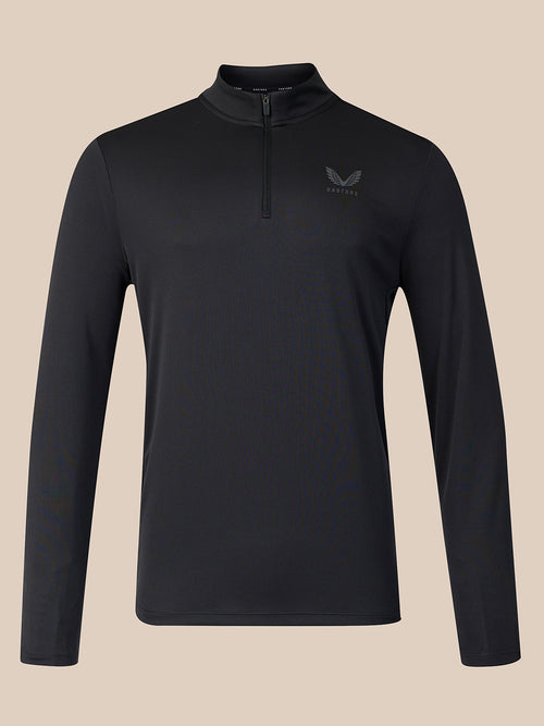 A black long-sleeve quarter-zip athletic top with a small dark gray wing logo on the left chest, displayed on a solid beige background.