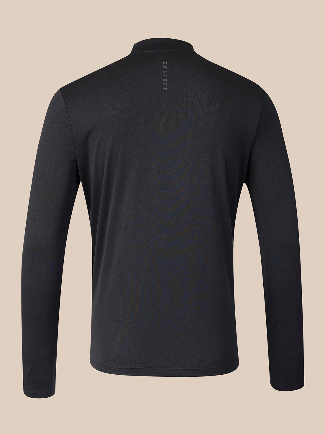 A black long-sleeve quarter-zip athletic top shown from the back, featuring a small vertical 'CASTORE' logo near the collar, set against a solid beige background.
