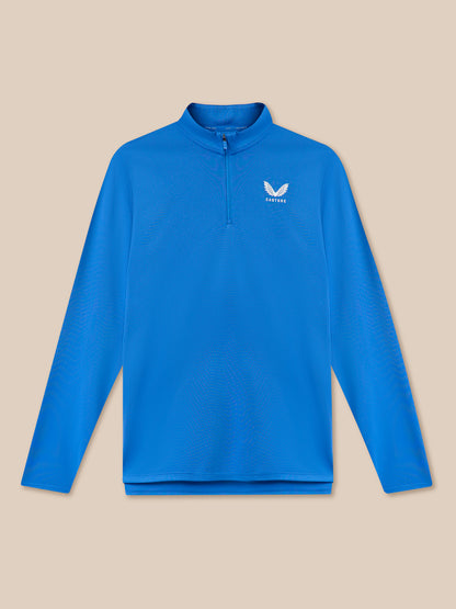 Blue long-sleeve shirt with a brand logo on a beige background