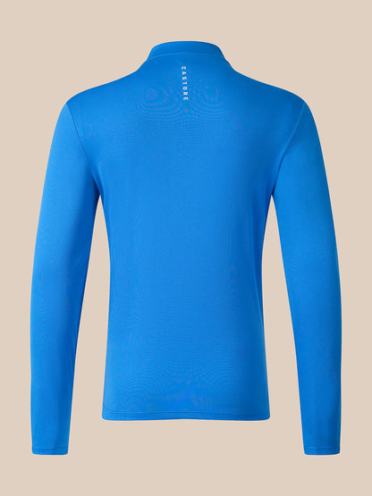 A bright blue long-sleeve athletic top shown from the back, featuring a mock neck and a small vertical white 'CaSTORE' logo printed at the center back, set against a solid beige background.