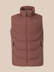 A sleeveless quilted puffer vest in a dusty rose-brown color, featuring a high collar, front zipper, and a small green wing logo on the left chest, set against a solid beige background.