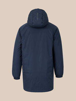 A dark navy hooded jacket shown from the back, featuring a vertical 'CASTORE' logo printed on the back of the hood, set against a solid beige background.