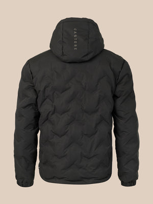 A black quilted hooded jacket shown from the back, featuring a vertical 'CASTORE' logo printed on the back of the hood, set against a solid beige background.