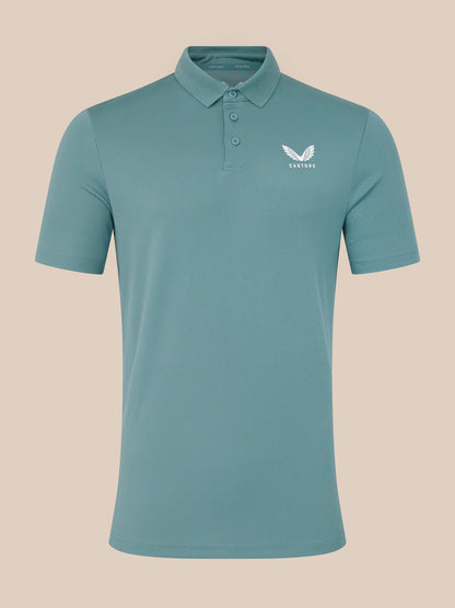 Teal polo shirt with a logo on a beige background