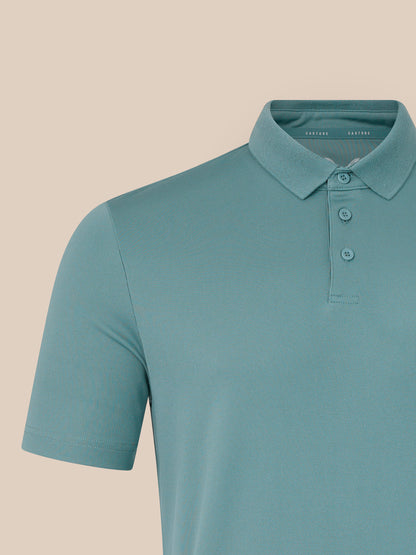 Teal polo shirt on a beige background