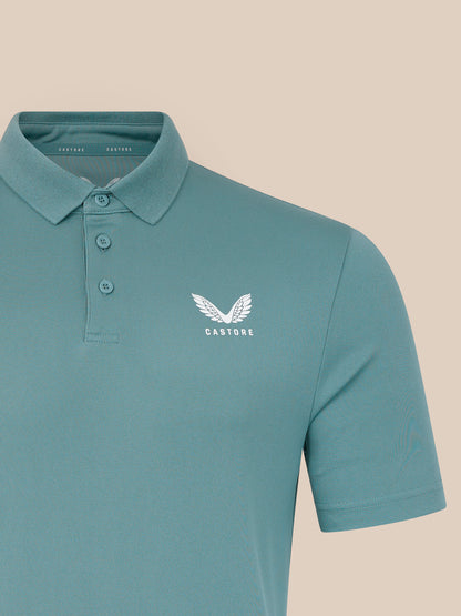 Teal polo shirt with a white logo on a beige background