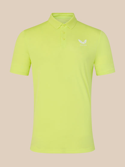 Yellow polo shirt with a logo on a beige background