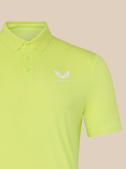 Light green polo shirt with a logo on a beige background