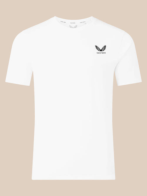 A white short-sleeve crewneck t-shirt with a small black winged logo and the brand name 'CASTORE' printed on the left chest, displayed against a solid beige background.