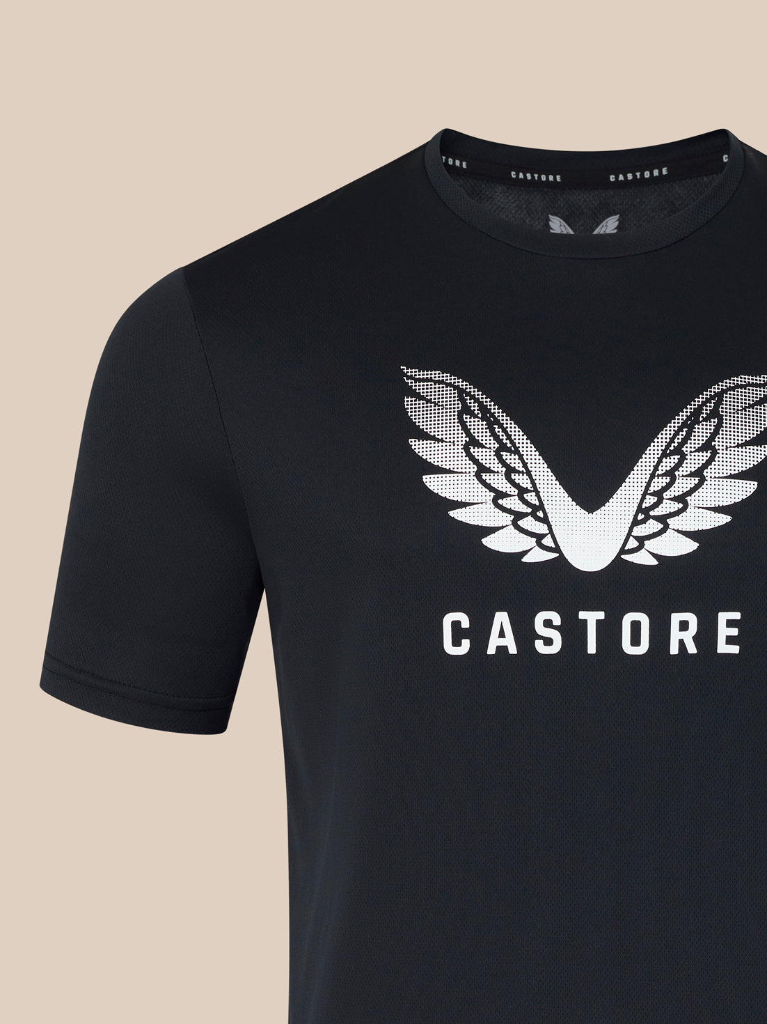 Black t-shirt with white 'Castore' logo on a beige background