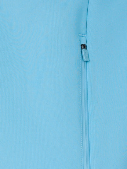 Close-up of a light blue fabric with a zipper on a matching background