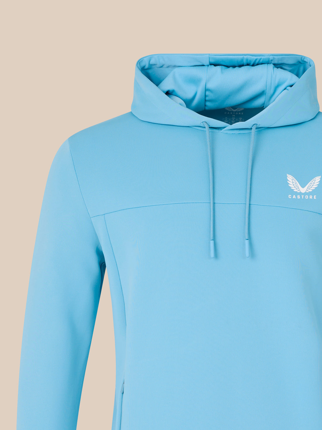 Light blue hoodie with a brand logo on a beige background
