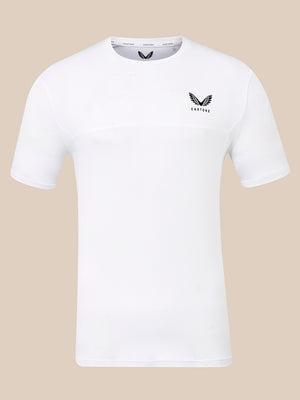 A white short-sleeve athletic t-shirt with a black winged logo and the word 'CASTORE' printed on the left chest, displayed against a solid beige background.