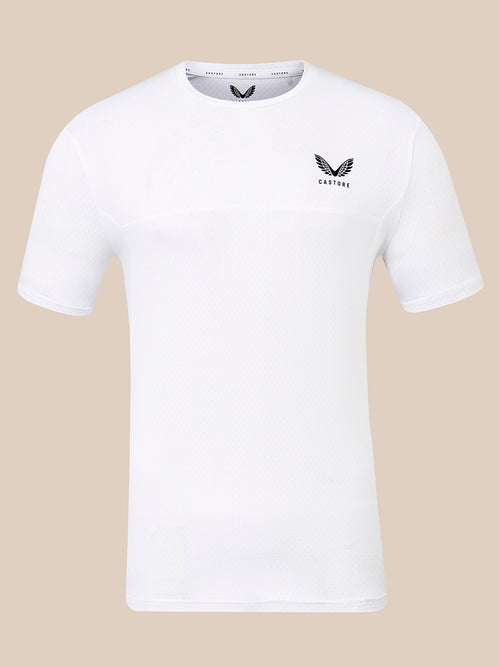 A white short-sleeve athletic t-shirt with a black winged logo and the word 'CASTORE' printed on the left chest, displayed against a solid beige background.