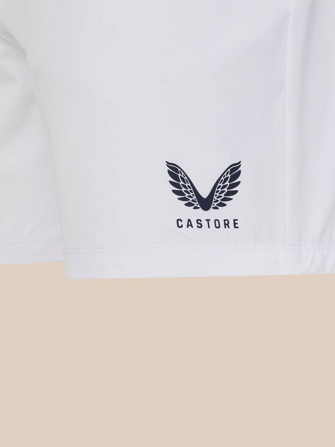 White t-shirt with a black logo and 'Castore' text on a beige background