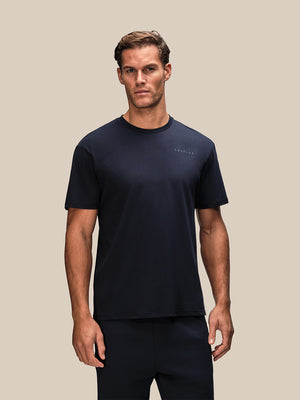 Male model wearing navy Flex short sleeve T shirt with small Castore logo on the chest