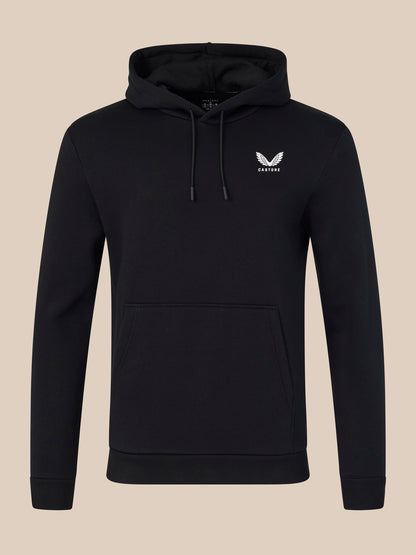 Black hoodie with a white logo on a beige background