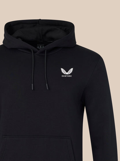 Black hoodie with a white logo on a beige background