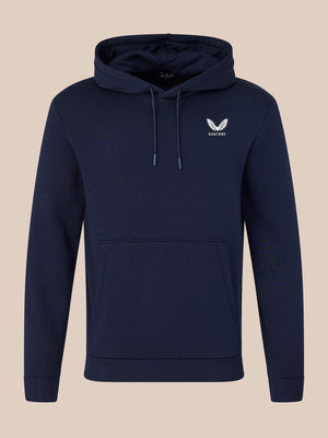Navy blue hoodie with a white logo on a beige background