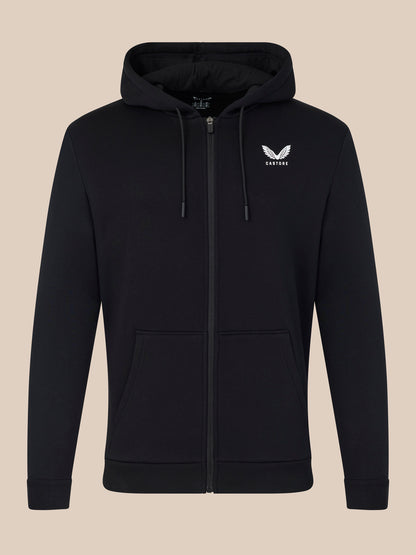 Black hoodie with a logo on the chest against a beige background