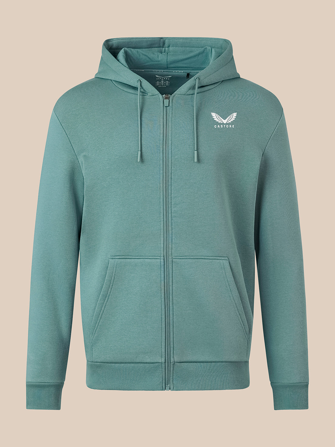 A teal green zip-up hoodie with a white winged logo on the left chest, displayed on a solid beige background.
