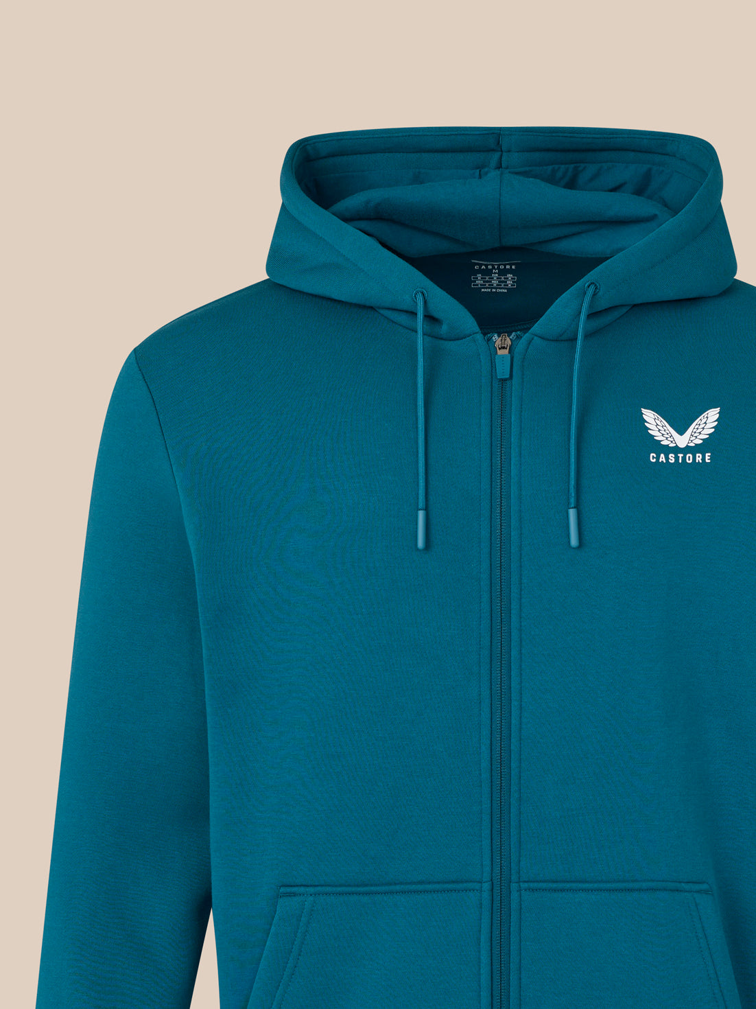Blue hoodie with a logo on a beige background