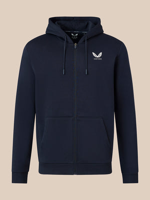 A navy blue zip-up hoodie with a white embroidered winged logo on the left chest, displayed on a solid beige background.