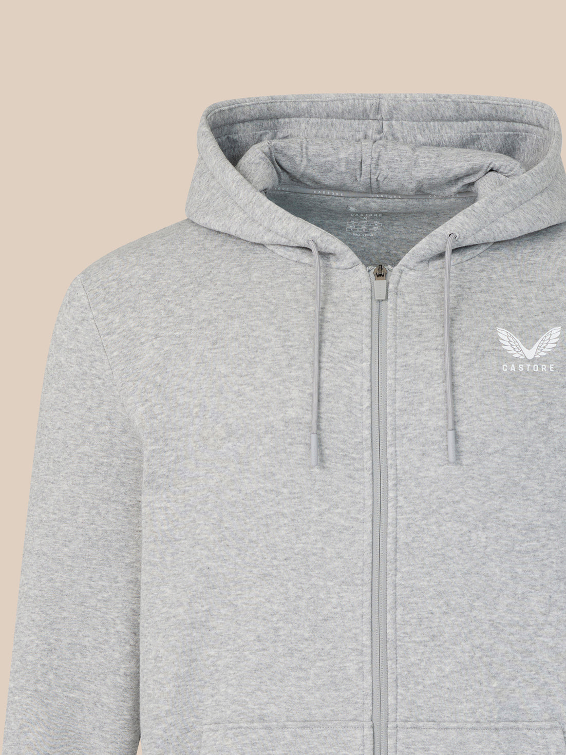 Gray hoodie with a brand logo on a beige background
