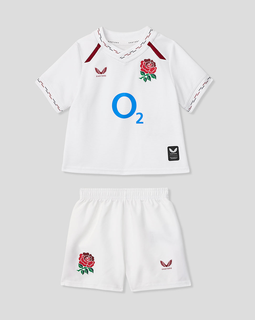 Children's sports kit with white shirt and shorts featuring rugby logos on a light gray background