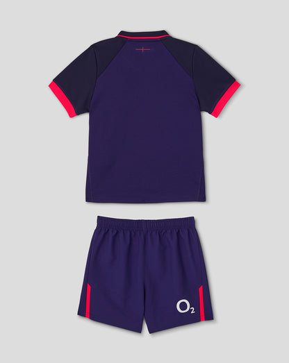 Navy sports outfit with red accents on a light gray background