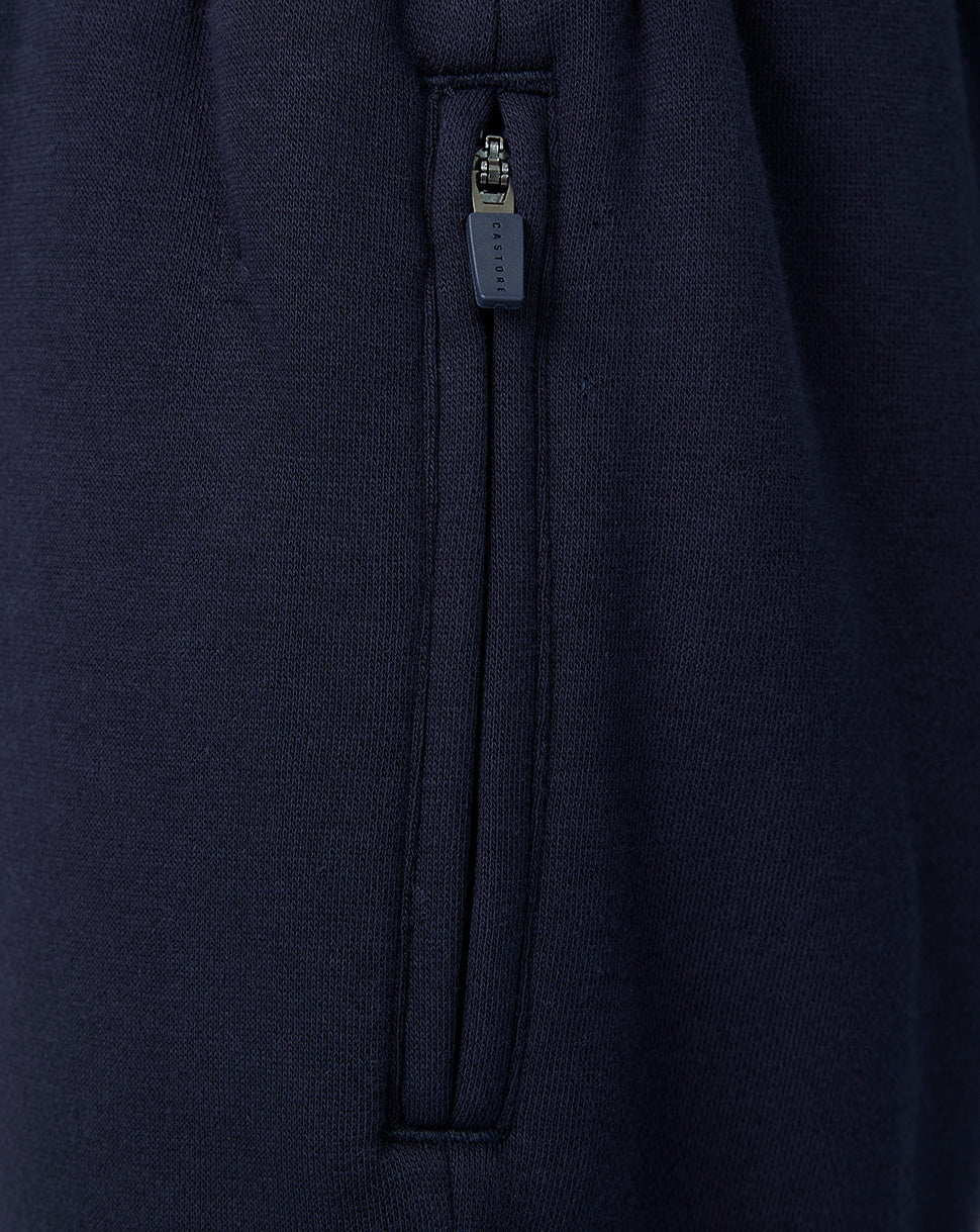 Close-up of navy travel shorts side zipper with Castore branding