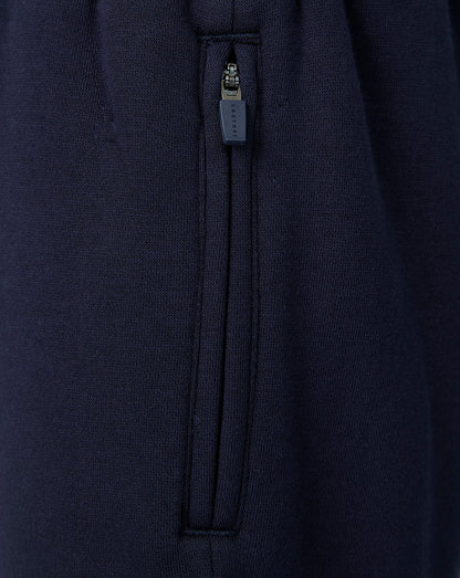 Close-up of navy travel shorts side zipper with Castore branding