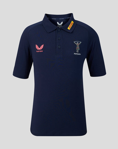 Navy blue polo shirt with brand logos on a light gray background