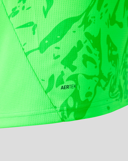 Close-up of a bright neon green athletic fabric with a tonal abstract pattern and the visible AERTEK logo near the lower edge.
