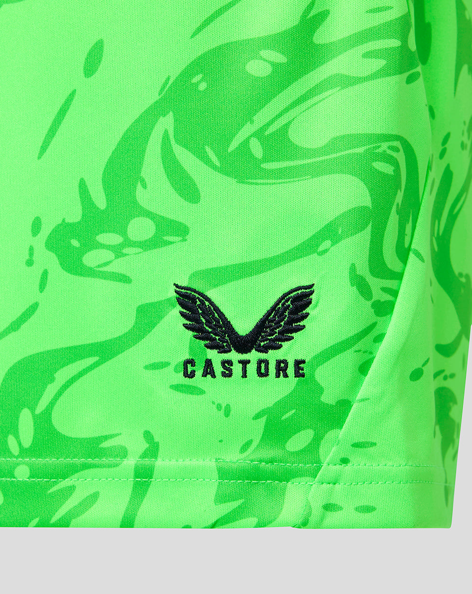 Close-up of a bright neon green athletic garment with a black Castore wing logo and brand name printed on the front.