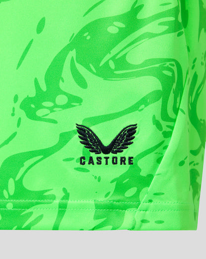 Close-up of a bright neon green athletic garment with a black Castore wing logo and brand name printed on the front.