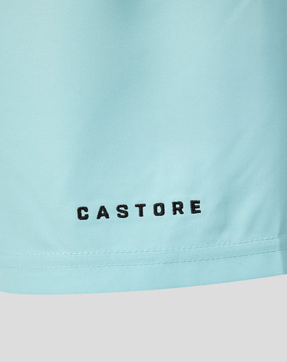 Close-up of a light pastel blue garment with the brand name 'CASTORE' printed in black across the lower front, above a stitched hem.