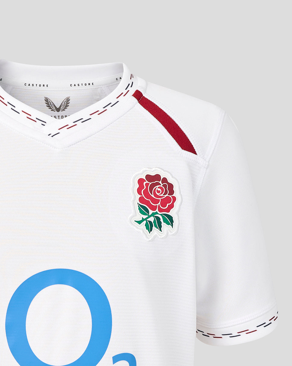 White sports jersey with a rose emblem and blue letter 'O' on a light gray background