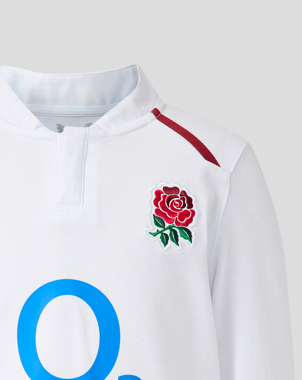 White sports jersey with a red rose emblem and blue lettering on a light gray background