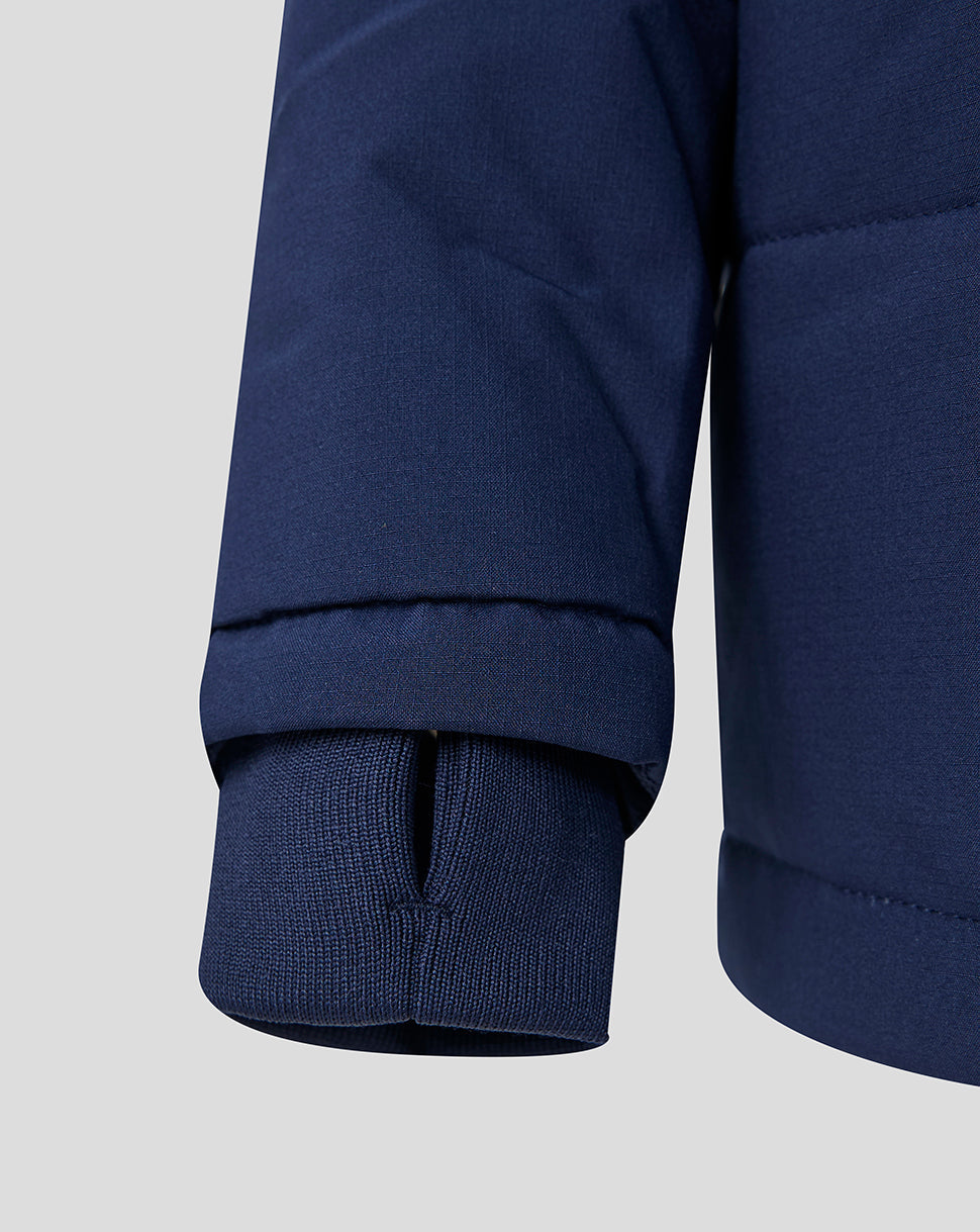 Close-up of a navy blue jacket with a focus on the sleeve and cuff.