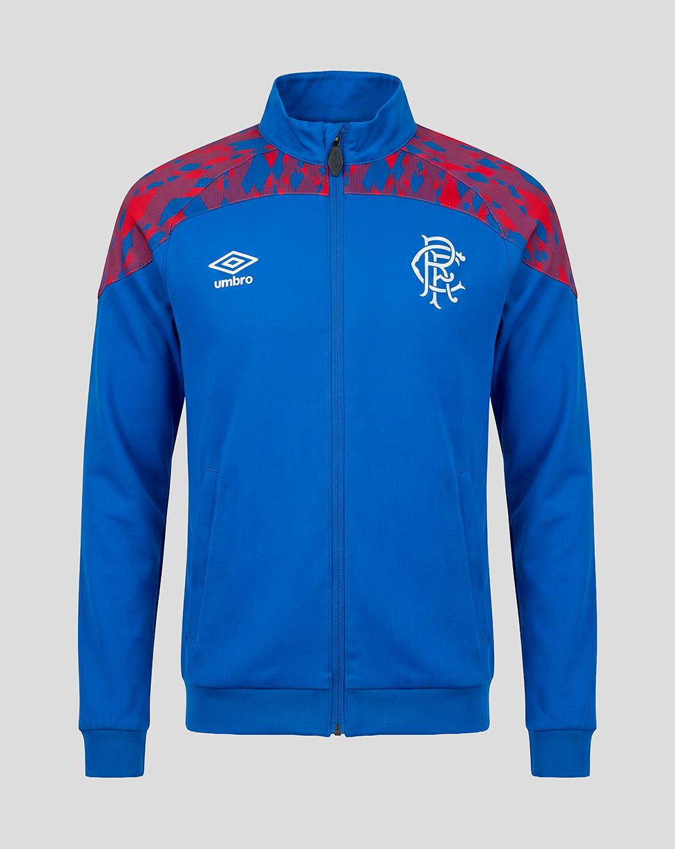 A royal blue zip-up track jacket featuring a red abstract pattern on the shoulders, a white Umbro logo on the right chest, and a white Rangers FC crest on the left chest, shown against a solid gray background.