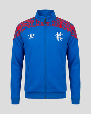 A royal blue zip-up track jacket featuring a red abstract pattern on the shoulders, a white Umbro logo on the right chest, and a white Rangers FC crest on the left chest, shown against a solid gray background.