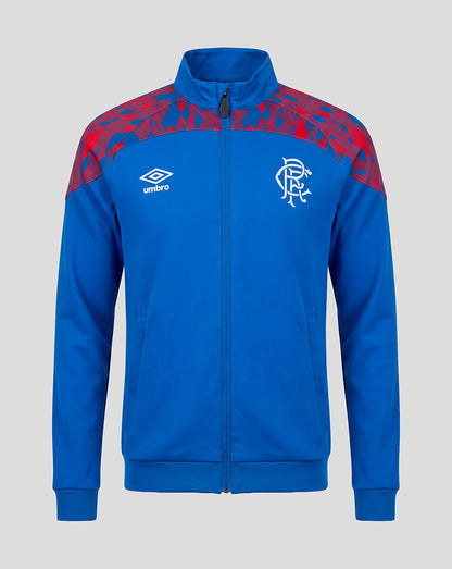 A royal blue zip-up track jacket featuring a red abstract pattern on the shoulders, a white Umbro logo on the right chest, and a white Rangers FC crest on the left chest, shown against a solid gray background.
