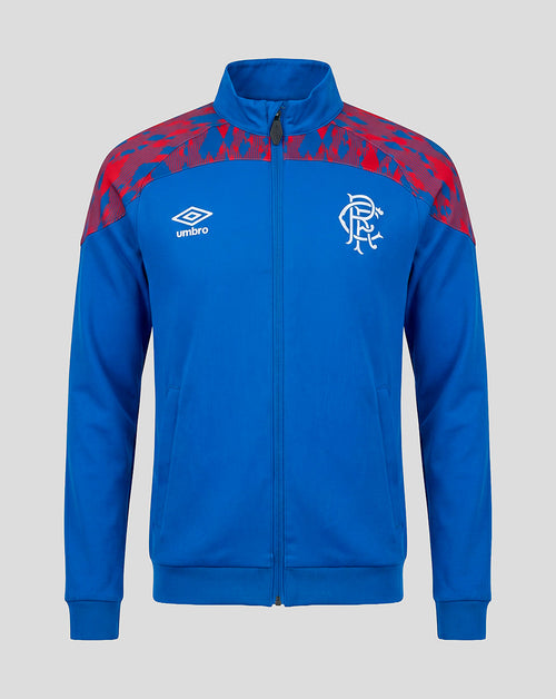 A royal blue zip-up track jacket featuring a red abstract pattern on the shoulders, a white Umbro logo on the right chest, and a white Rangers FC crest on the left chest, shown against a solid gray background.
