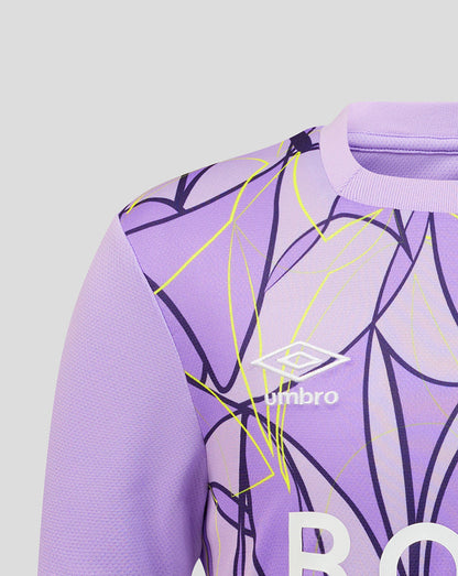 Close-up of a purple football jersey with a yellow and dark purple abstract line pattern, featuring the white Umbro logo on the chest.